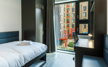 Room in the UCD Student Village, featuring a bed, desk and wardrobe, overlooking the courtyard.